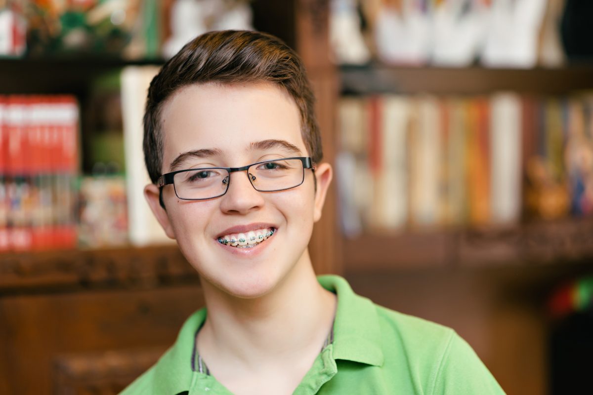 Boy with braces and a healthy smile.