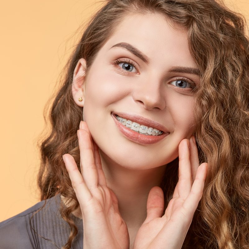 Smiling woman with curly hair wearing braces in Sparks, Nevada