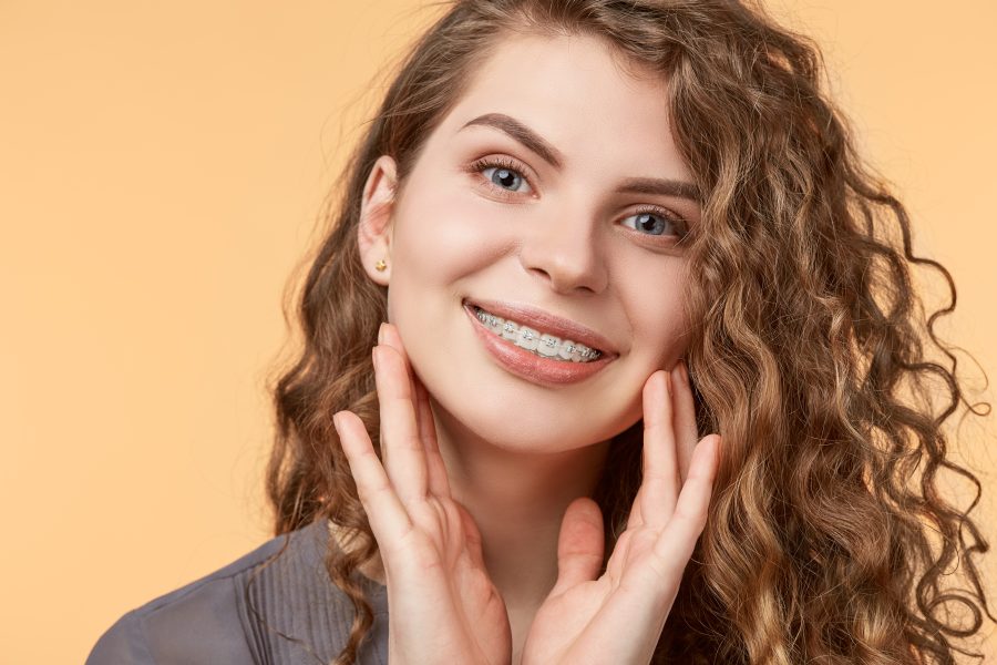 Smiling woman with curly hair wearing braces in Sparks, Nevada